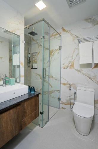 a bathroom with a shower and a toilet and a sink at h78 Guraidhoo in Guraidhoo