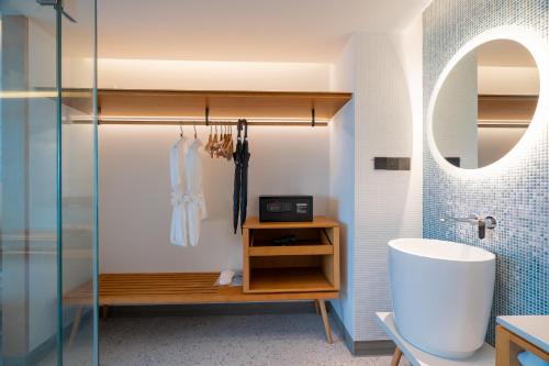 a bathroom with a shower and a sink and a mirror at Wyndham Garden Phuket Kamala in Kamala Beach