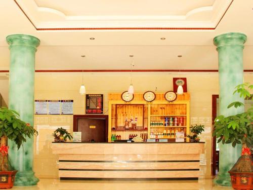 a bar in a room with two columns at Putian Meizhou Island Lanhai Hotel in Putian