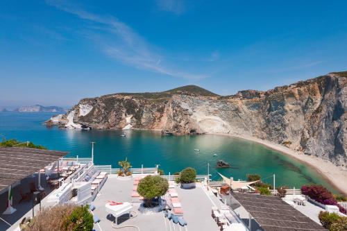 a view of a beach with a bunch of chairs at Hotel Chiaia Di Luna in Ponza