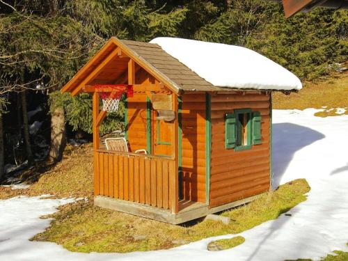 a wooden dog house with snow on top of it at Chalet in Flachau near Ski Slopes in Flachau