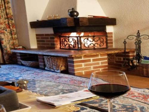 a glass of wine sitting on a table in front of a fireplace at Chalet in Flachau near Ski Slopes in Flachau