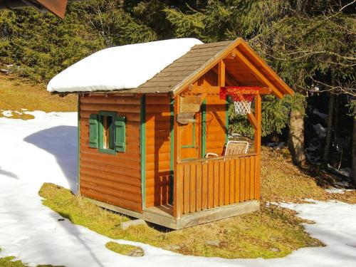 a small wooden house with snow on top of it at Chalet in Flachau near Ski Slopes in Flachau