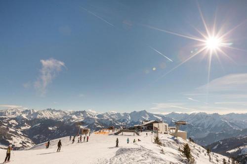 a group of people skiing down a snow covered mountain at Apartment building, Fügen in Fügen