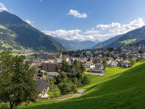 a town on a hill with mountains in the background at Apartment building, Fügen in Fügen