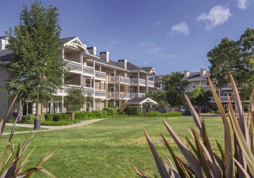 a large apartment building with a green yard at WorldMark Windsor in Windsor