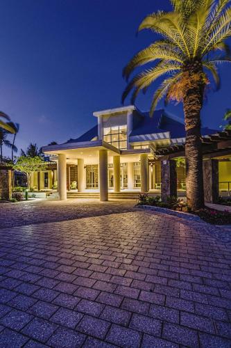 a large house with a palm tree in front of it at Margaritaville Vacation Club - St Thomas in Frydendal