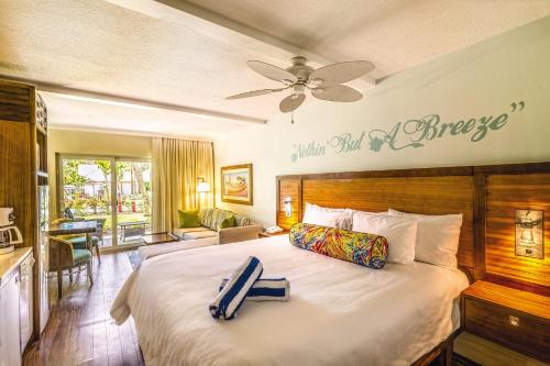 a hotel room with a large bed with a pineapple sign on the wall at Margaritaville Vacation Club - St Thomas in Frydendal
