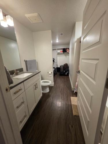 a small bathroom with a toilet and a sink at Shared apartment in Salt Lake City
