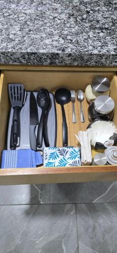 a drawer filled with utensils on top of a counter at pent-house 3 planta alta in San José del Cabo