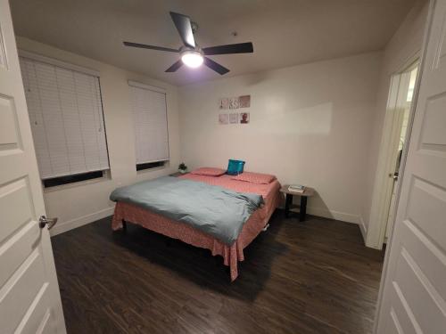 a bedroom with a bed and a ceiling fan at Shared apartment in Salt Lake City