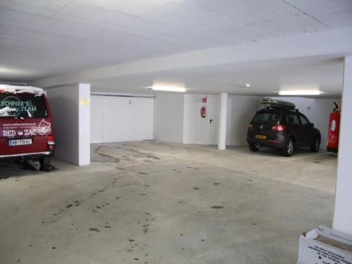 a parking garage with two cars parked in it at Apartment in Leogang near Ski Slopes in Leogang