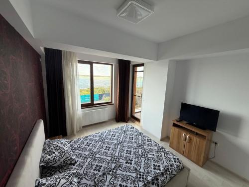 a bedroom with a bed and a flat screen tv at Summerland Flat in Mamaia