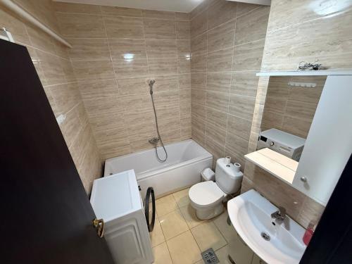a bathroom with a white toilet and a sink at Summerland Flat in Mamaia