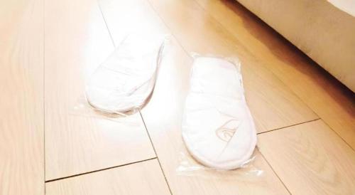 a pair of white shoes sitting on a floor at London Hotel in Macau