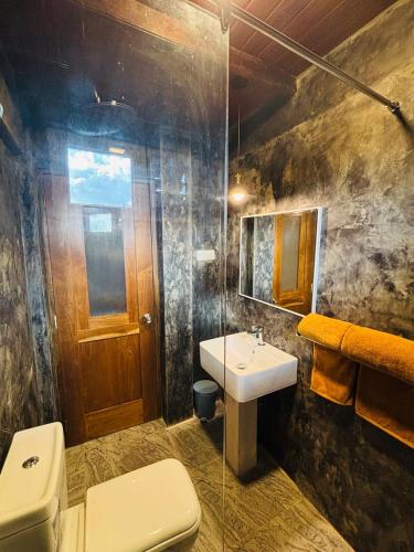 a bathroom with a toilet and a sink at Heavenly Horizon Villa in Kandy