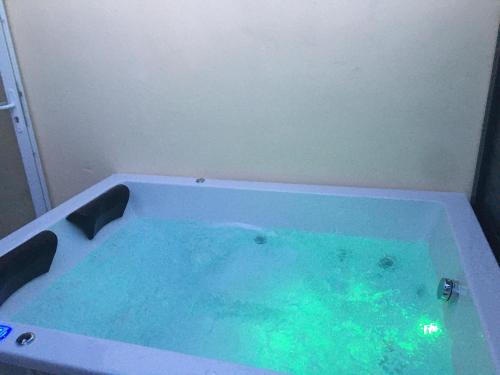 a bath tub filled with water in a room at chambres d hotes Le Mas Julien piscine chauffée adult only in Orange