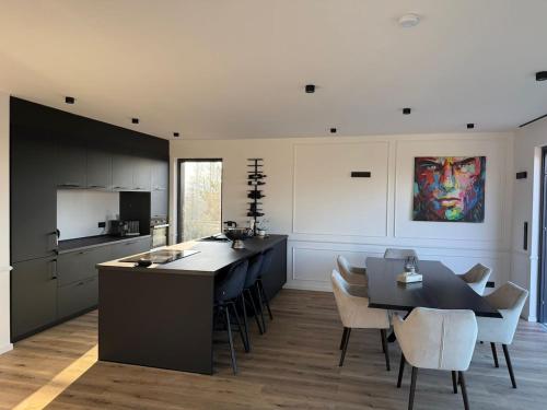 a kitchen with a table and chairs and a dining room at Exclusive apartment with a hot tub and view in Niederdorla
