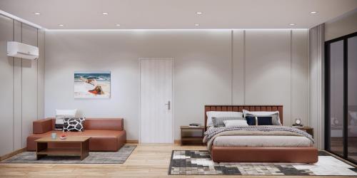 a bedroom with a bed and a couch at Private Villa by YUSETH Residence in Phumi Ta Phul
