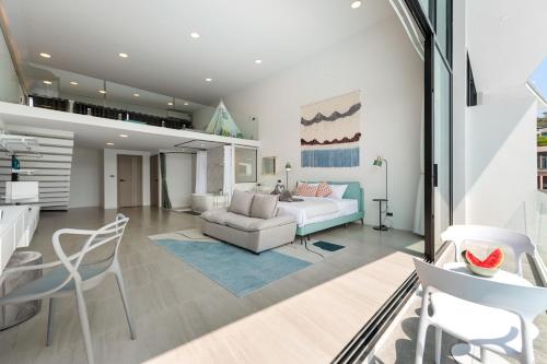 a living room with a bed and a couch at Pool Access Spacious Townhouse and Kids Slide in Koh Samui