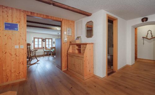 a living room with wooden floors and a dining room at Cricerhaus in Visp