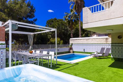 a backyard with a table and a swimming pool at Casa MEDITERRANEA in Salou