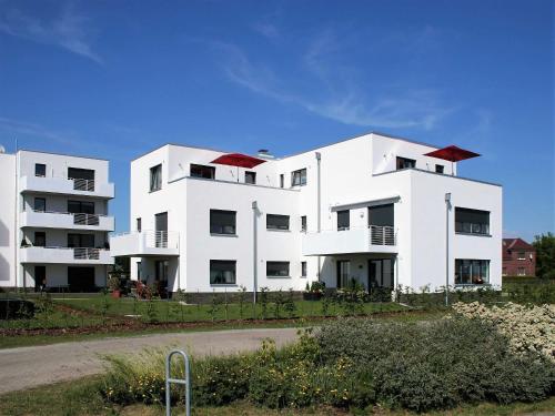two white apartment buildings on the side of a road at Ferienwohnung Penthaus ILSE in Großräschen