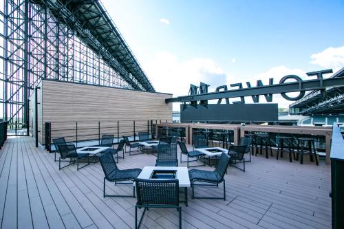 a group of chairs and tables on a deck at tower eleven hotel in Kitahiroshima