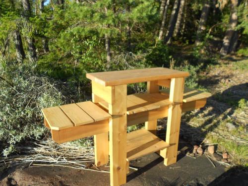 a wooden bench sitting on the ground in a park at Tornvillan in Hammarland