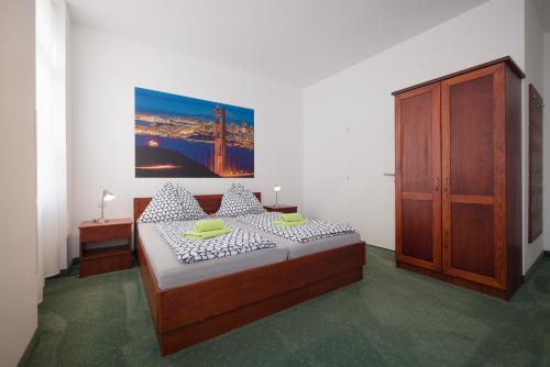 a bedroom with a bed and a large painting on the wall at Pension San Francisco in Vienna