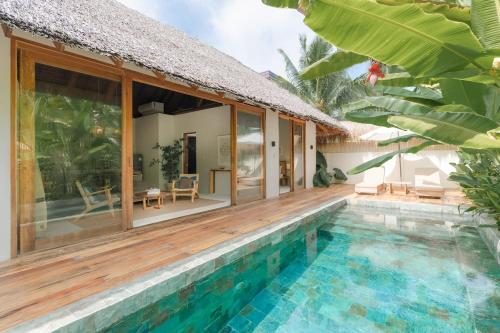 a villa with a swimming pool and a house at Villa Veloso A Private Villa with Pool in Sta Fe Siargao in General Luna