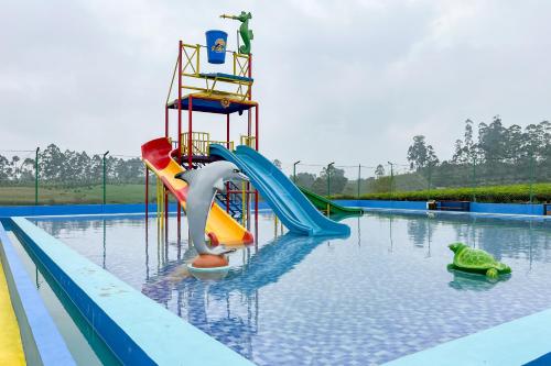 a water park with a water slide in a pool at S Tilu Heroy Hill Resort Pangalengan Bandung RedPartner in Pengalengan