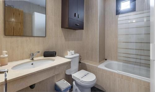 a bathroom with a toilet and a sink and a tub at Montegorbea Studio superior con parking privado incluido NEVADAHOME in Sierra Nevada