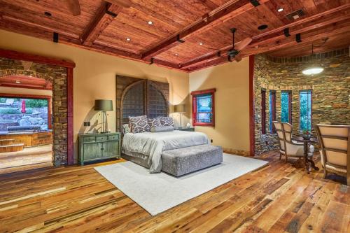 a bedroom with a bed and a table and chairs at Castle On Black Mountain breathtaking panoramic views and outdoor entertainment in Cave Creek