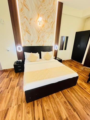 a bedroom with a bed with a wooden floor at Nandan Retreat 4-Star Hotel & Luxury Villas Near Prem Mandir, Vrindavan in Vrindāvan
