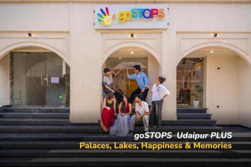 a group of people standing outside of a building at goSTOPS PLUS Udaipur Gulab Bagh in Udaipur