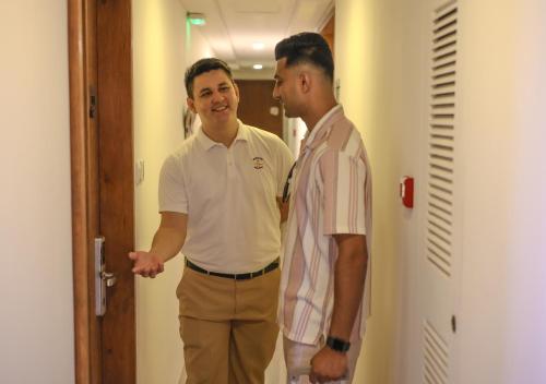 two men standing next to each other in a hallway at Seasalter Maldives in Hulhumale
