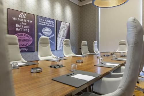 a conference room with a long wooden table and chairs at Omni Louisville Hotel in Louisville