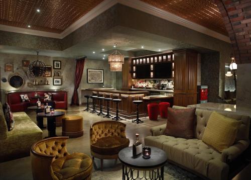 a living room with a couch and a bar at Omni Louisville Hotel in Louisville