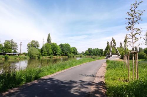 a road next to a river with a bridge at Apartment Holata 201 in Hradec Králové