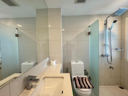 a bathroom with a sink and a toilet and a shower at City Center Residence & Hot Hot Hot in Pattaya Central