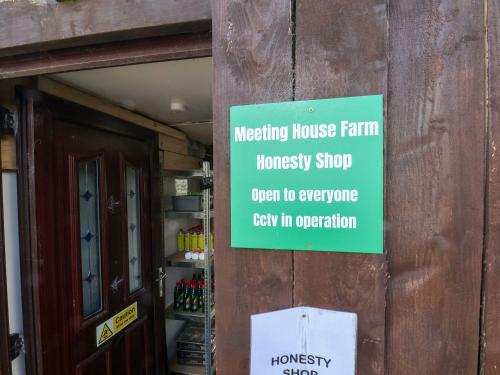 a sign on the side of a house a housekeeping house farm house at Mini pod in Scarborough
