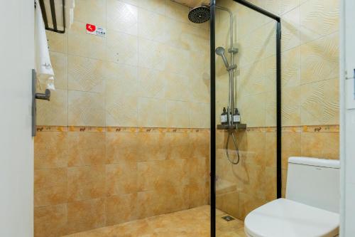 a bathroom with a shower with a toilet at The Lu Village Retreat in Guilin