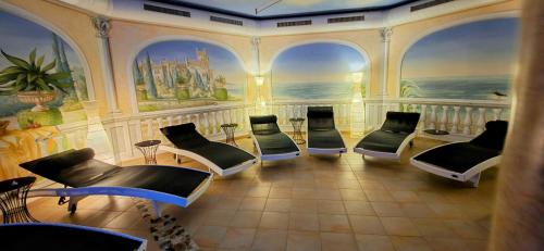 a waiting room with chairs and a painting on the wall at Romantikschlössl Loipersdorf Adults Only in Grieselstein