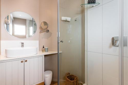 a bathroom with a sink and a shower at Camps Bay Village in Cape Town