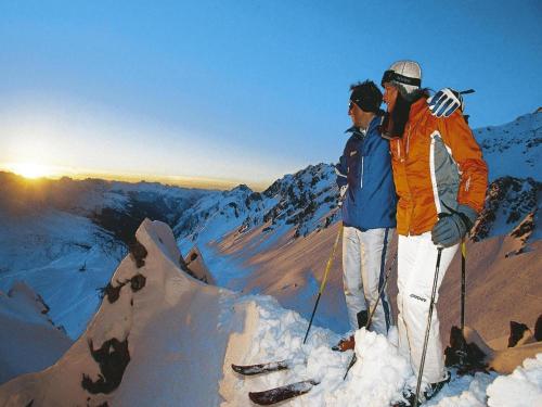 two people standing on top of a snowy mountain at Apartment in Bichlbach at the lake in Bichlbach