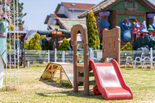 a playground with a slide in a park at Lala Land Pet Friendly Pension in Gyeongju