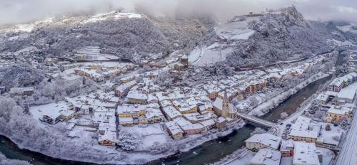 an aerial view of a city covered in snow at Cityhotel Goldener Adler B&B in Chiusa