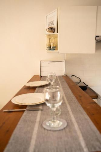 a table with two wine glasses on top of it at 15 minutes from Athens airport in Porto Rafti