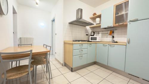 a small kitchen with a table and a counter top at GAUDIO APPARTAMENTs A DUE PASSI DAL TEATRO ARISTON NEL CENTRO DI SANREMO in Sanremo